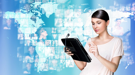 Portrait of young woman holding her tablet computer and communic