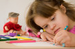 © philidor - Close up of a girl with Down syndrome drawing.