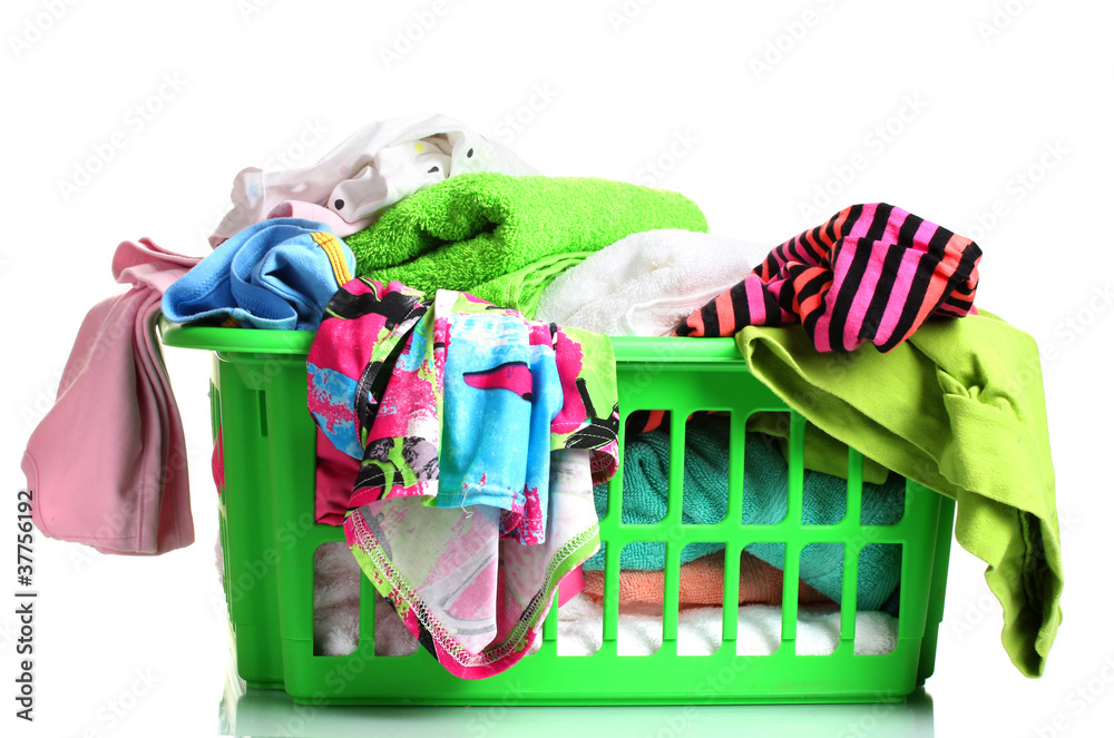 Clothes in green plastic basket isolated on white