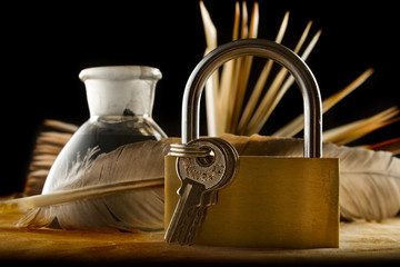 Canvas Print - A feather, inkpot, old book and keylock