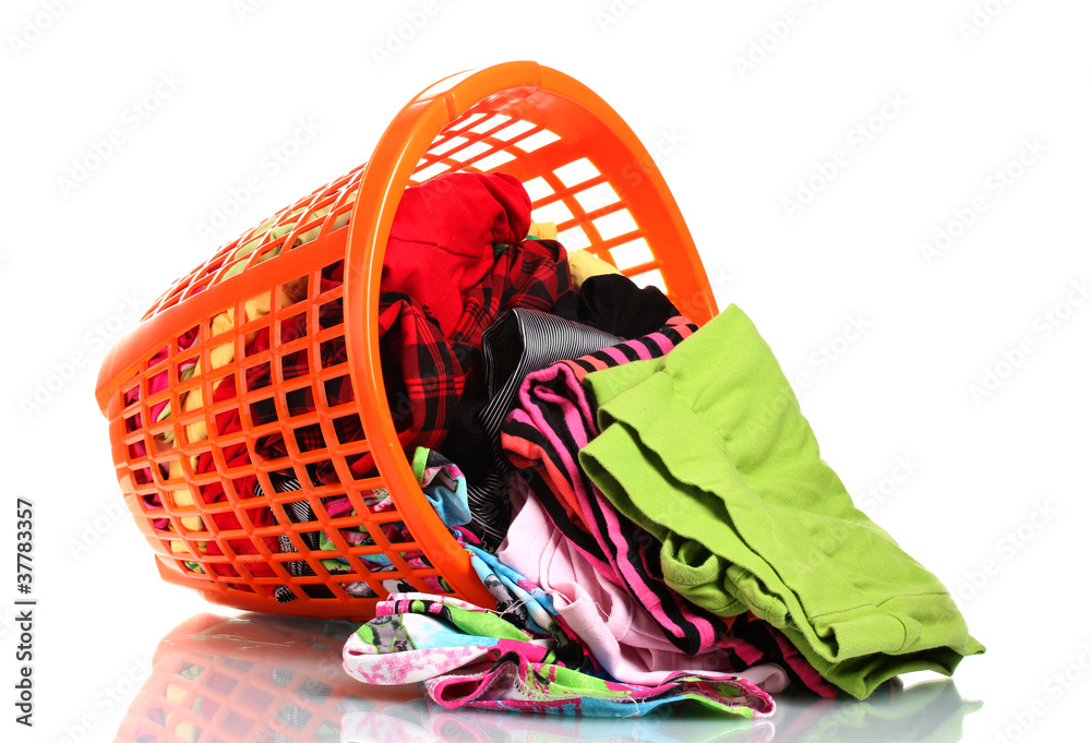 Clothes in orange plastic basket dropped isolated on white