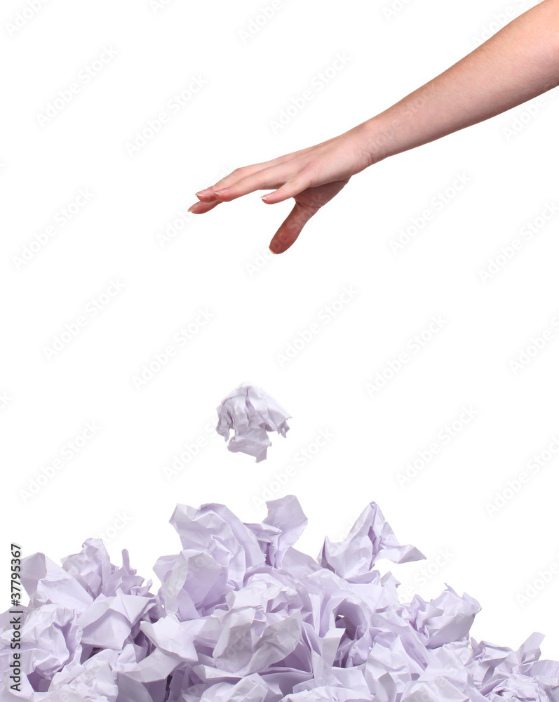 stack of crumpled paper balls and hand isolated on white