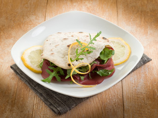 Wall Mural - chapati sandwich  with bresaola and arugula salad