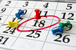 Closeup calendar page with drawing-pins