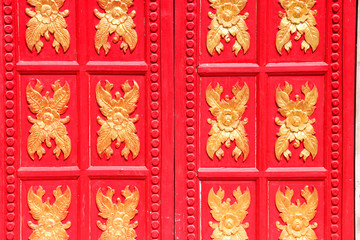 Flowers sculpture on red wooden window