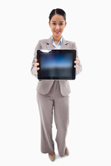 Poster - Portrait of a businesswoman showing a tablet computer