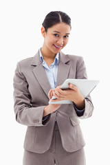 Poster - Portrait of a smiling businesswoman using a tablet computer