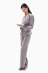 Poster - Smiling businesswoman working on tablet