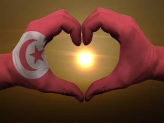 Heart and love gesture by hands colored in tunisia flag during b