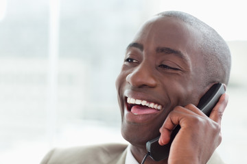 Wall Mural - Close up of a laughing businessman on the phone