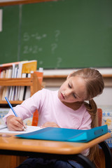 Poster - Portrait of a focused schoolgirl writing