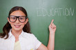 © WavebreakmediaMicro - Smart schoolgirl pointing at a word
