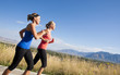 © Brocreative - Side view of Two Female joggers running outdoors