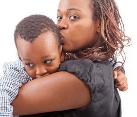 Wall Mural - Young afro american mother with her son isolated over a white ba