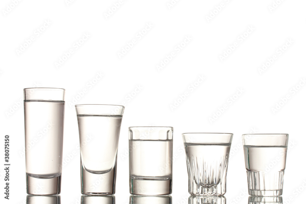 Many glass of vodka isolated on white