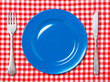 © elnavegante - Blue dinner plate with fork and knife