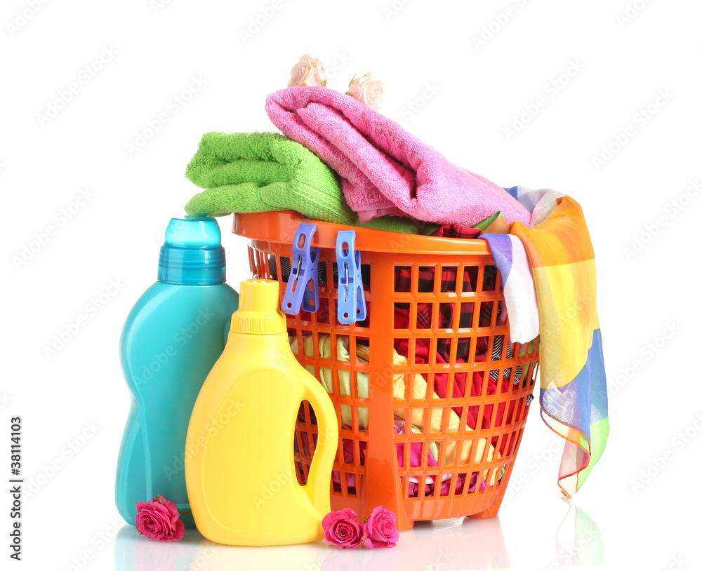 Clothes with detergent in orange plastic basket isolated