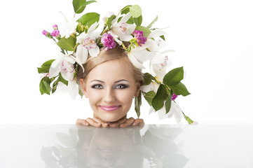 pretty blond with flower crown on head, she looks in to the lens