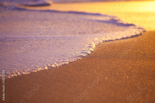 Nowoczesny obraz na płótnie Wave Washing on Sand at Sunset, Shallow Depth of Field