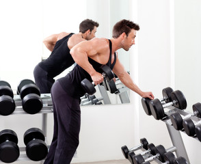 Wall Mural - man with weight training equipment on sport gym