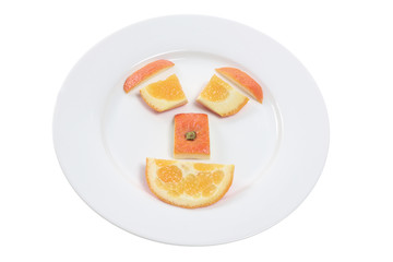 Canvas Print - Orange Pieces Arranged in Shape of Face  on Plate