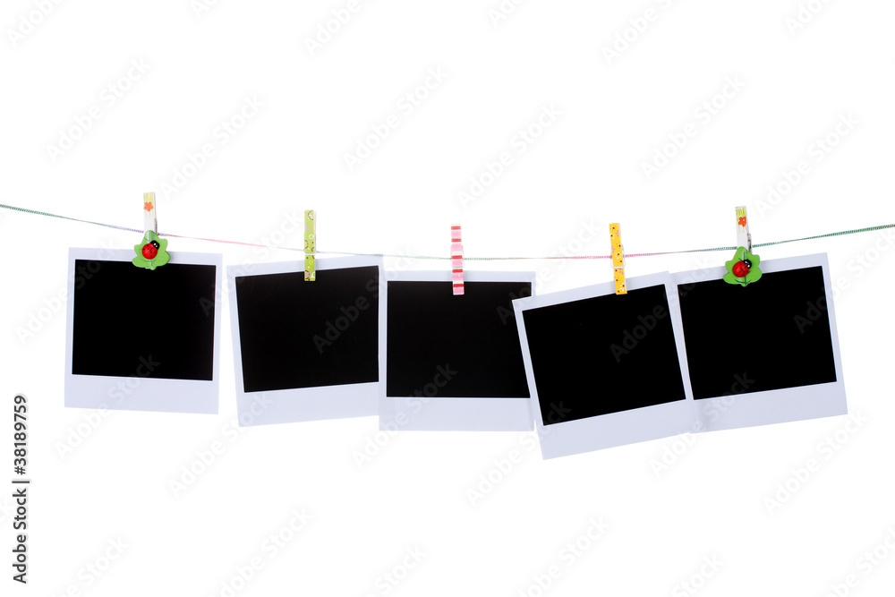 Photo paper hanging on the clothesline isolated on white