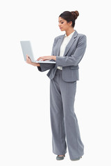 Poster - Businesswoman using laptop while standing