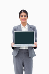 Poster - Smiling businesswoman showing her laptop