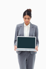 Poster - Businesswoman looking at laptop in her hands