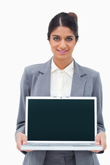 Poster - Smiling saleswoman showing screen of her laptop
