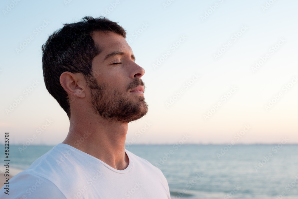 Handsome man deep breathing on the beach - obrazy, fototapety, plakaty 