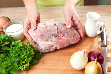 The frozen meat on a kitchen table.