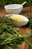 Fototapeta Lawenda - Assorted fresh herbs with olive oil