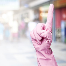 Woman With Pink Gloves Gesturing Against A Crowded Place