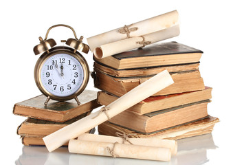 Wall Mural - Pile of old books with clock and scroll isolated on white