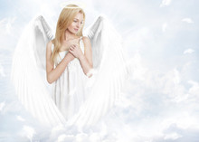 Young Woman As Angel With White Wings And Aureole