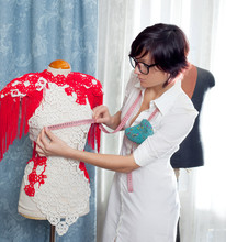 Dressmaker With Mannequin Working At Home