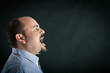 © pio3 - Angry man shouting against black background