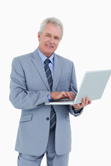 Poster - Smiling mature tradesman with his notebook
