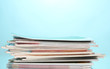 © Africa Studio - stack of magazines on blue background
