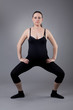© EwaStudio - Pregnant woman doing gymnastic exercises on grey background.