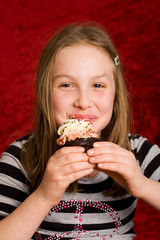 Happy Child eating a cupcake