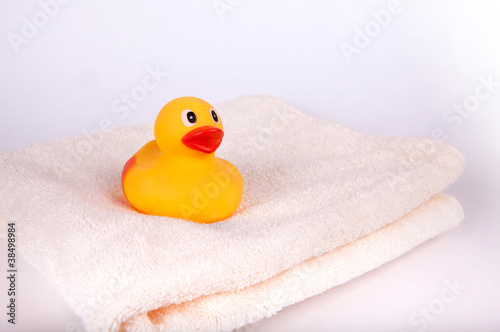 Fotografie, Obraz Rubber duck on white towel isolated on white