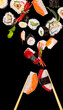 Sushi pices flying on black background