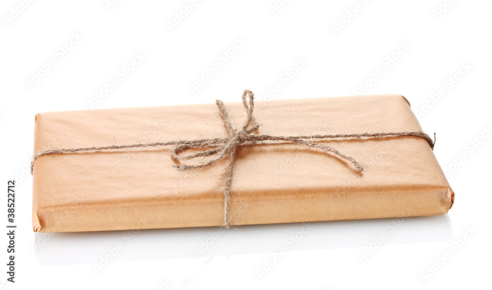 Parcel wrapped in brown paper tied with twine isolated on white