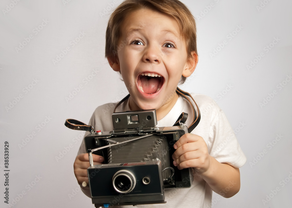 Happy photographer boy ,child ,kid taking a picture with a Polaroid style instant camera - obrazy, fototapety, plakaty 