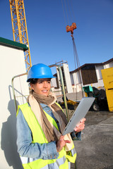 Architect on building site using electronic tablet