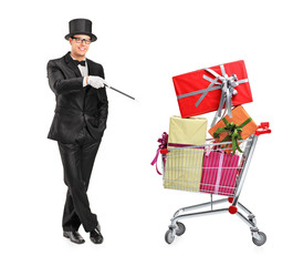 Wall Mural - Magician performing a trick on a shopping cart full of presents