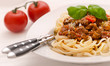 Spaghetti bolognese garnished with basil
