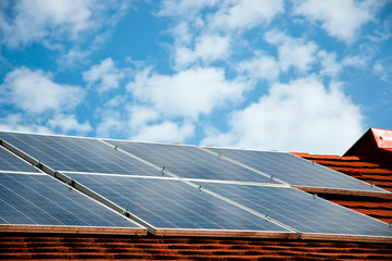 Cells of solar energy panels on the roof of a building